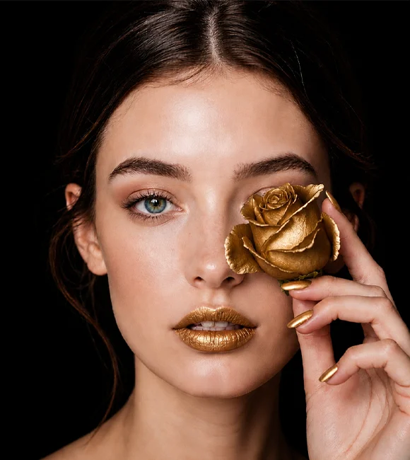 Beauty spa model with gold-themed makeup