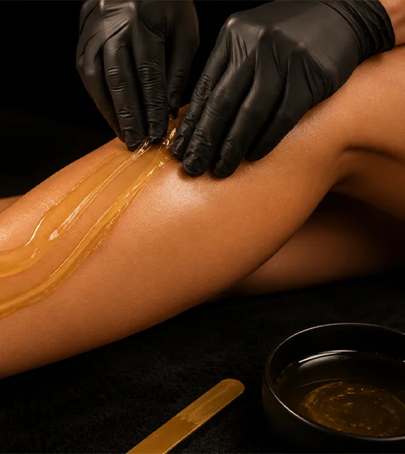 Professional leg waxing service at spa